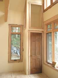 Trim around coat closet door, the opening above it, and the windows